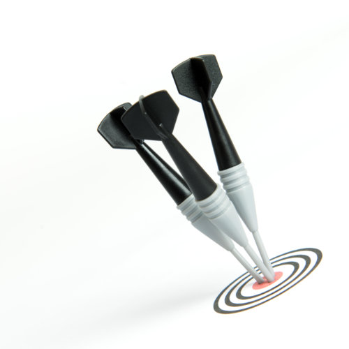 Three black darts pinned right on the center of dartboard Three black darts pinned right on the center of dartboard